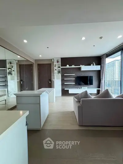 Modern living room with sleek design, large windows, and built-in entertainment unit.
