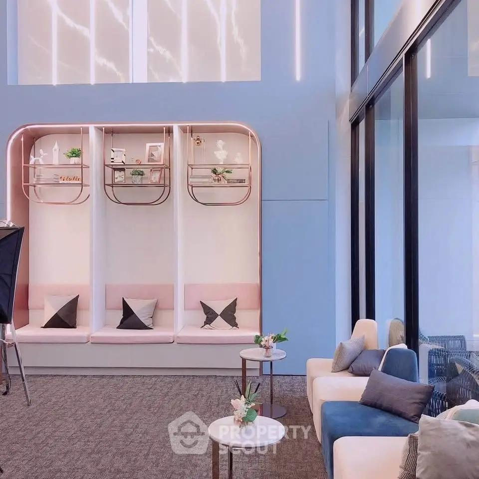 Stylish modern lounge area with elegant seating and decorative shelves, perfect for relaxation and socializing.