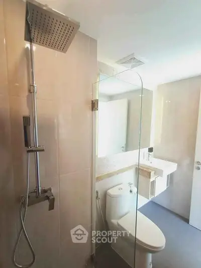 Modern bathroom with sleek fixtures and glass shower enclosure