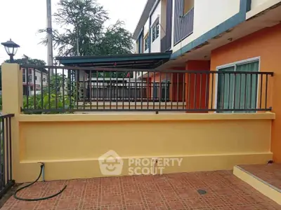 Charming townhouse exterior with spacious balcony and modern design.