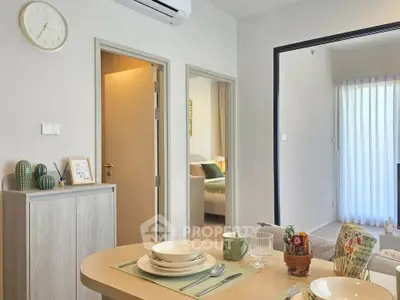 Modern dining area with stylish decor and view into cozy bedroom