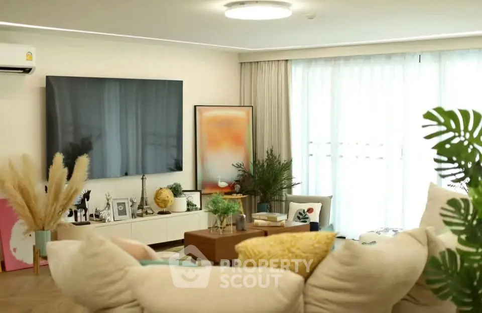 Spacious modern living room with large TV and elegant decor