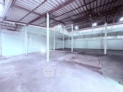 Spacious industrial warehouse with high ceilings and open floor plan, ideal for storage or manufacturing.