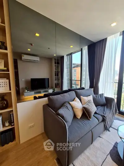 Modern living room with cozy sofa and large windows offering city views