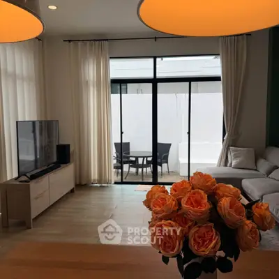 Modern living room with large windows, cozy sofa, and elegant decor, perfect for relaxation and entertainment.