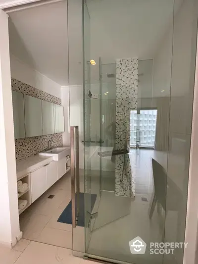 Modern bathroom with glass shower and stylish mosaic tiles