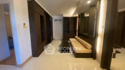 Modern living room with sleek dark wood furniture and ambient lighting