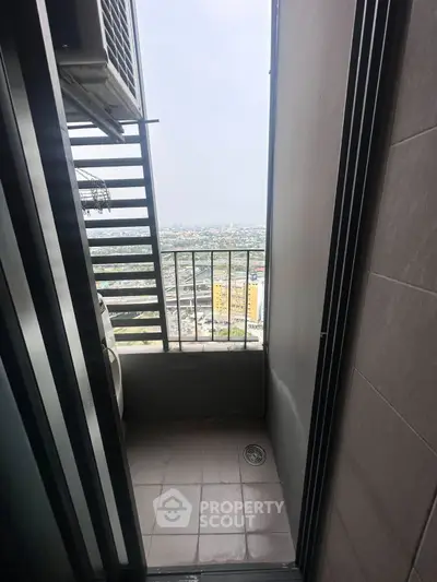 High-rise balcony with city view and air conditioning unit, perfect for urban living.