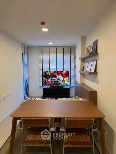 Modern living room with stylish furniture and large TV, perfect for cozy gatherings.