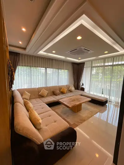 Luxurious living room with large sectional sofa and elegant ceiling lights
