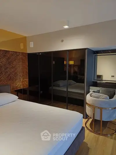 Luxurious bedroom with modern decor and mirrored wardrobe doors