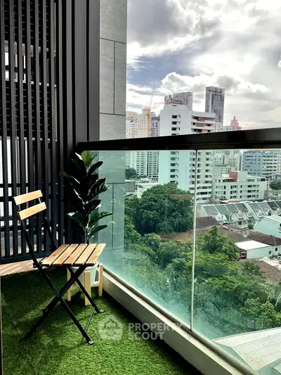 Stunning city view from a modern balcony with artificial grass and seating area.