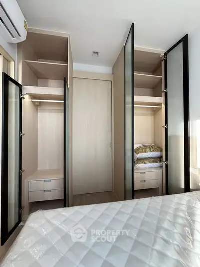 Modern bedroom with built-in wardrobes and sleek design, perfect for maximizing storage space.