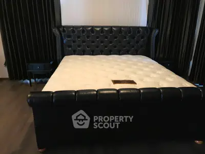Luxurious bedroom with elegant leather bed and stylish decor