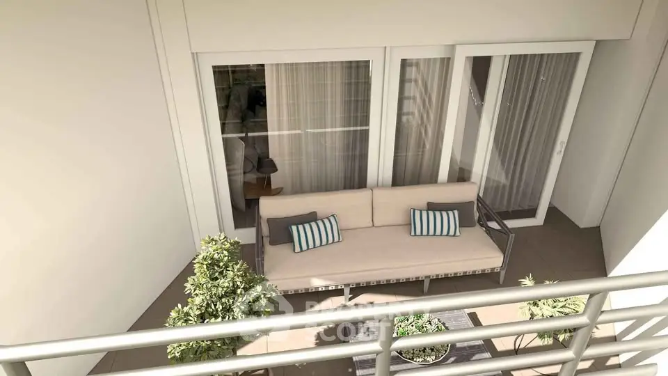 Modern balcony with cozy seating and greenery, perfect for relaxation.