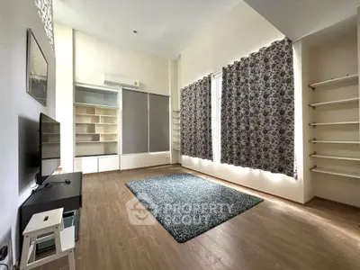 Spacious living room with modern decor and ample natural light