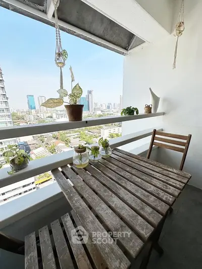 Charming balcony with rustic wooden table and city skyline view, perfect for relaxing and enjoying the outdoors.