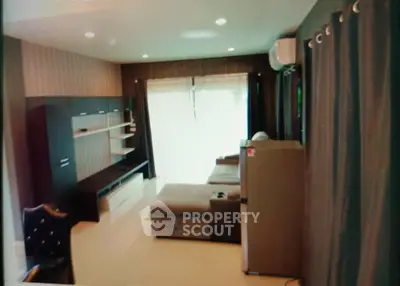 Spacious living room with modern furniture and large windows for natural light.