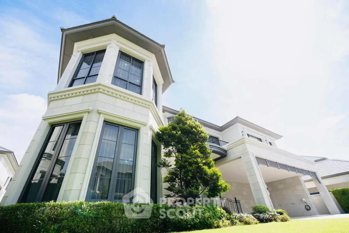 Stunning modern house exterior with lush garden and unique architectural design.