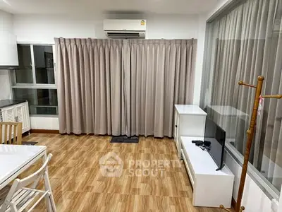 Modern living room with air conditioning and stylish curtains in a cozy apartment.