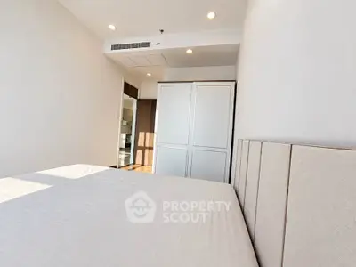 Modern bedroom with minimalist design and ample natural light