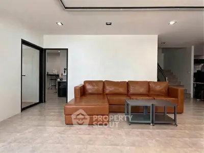 Spacious modern living room with stylish leather sofa and sleek design