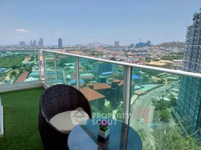 Stunning balcony view with modern cityscape and cozy seating area.