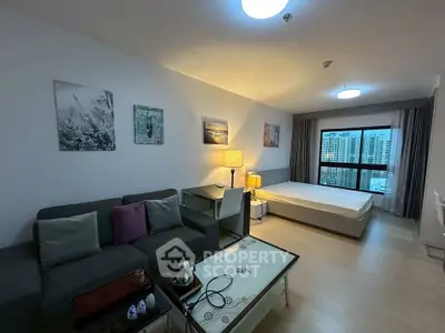 Modern studio apartment with cozy living area and city view, featuring stylish decor and ample natural light.