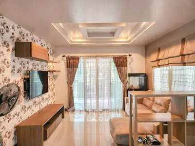 Spacious living room with modern decor and large windows for natural light.