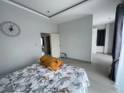 Spacious bedroom with modern decor and natural light