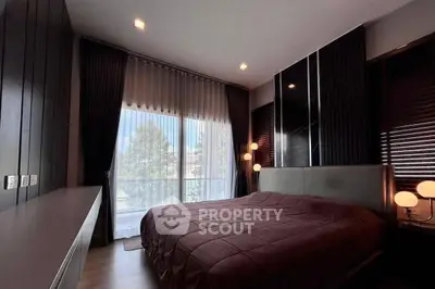 Luxurious bedroom with modern design, large window, and elegant lighting for a serene ambiance.