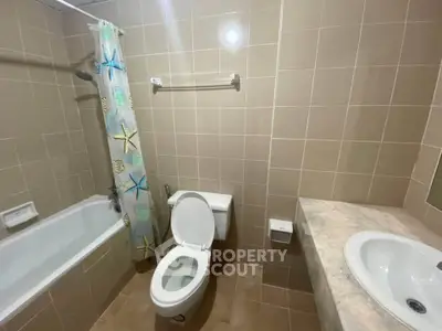 Spacious bathroom with bathtub and modern fixtures in a contemporary apartment.