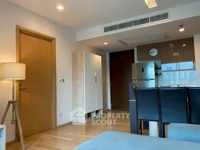 Modern apartment interior with sleek kitchen and cozy living area.