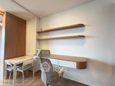 Modern study room with sleek desk, ergonomic chair, and minimalist shelves in a stylish apartment.