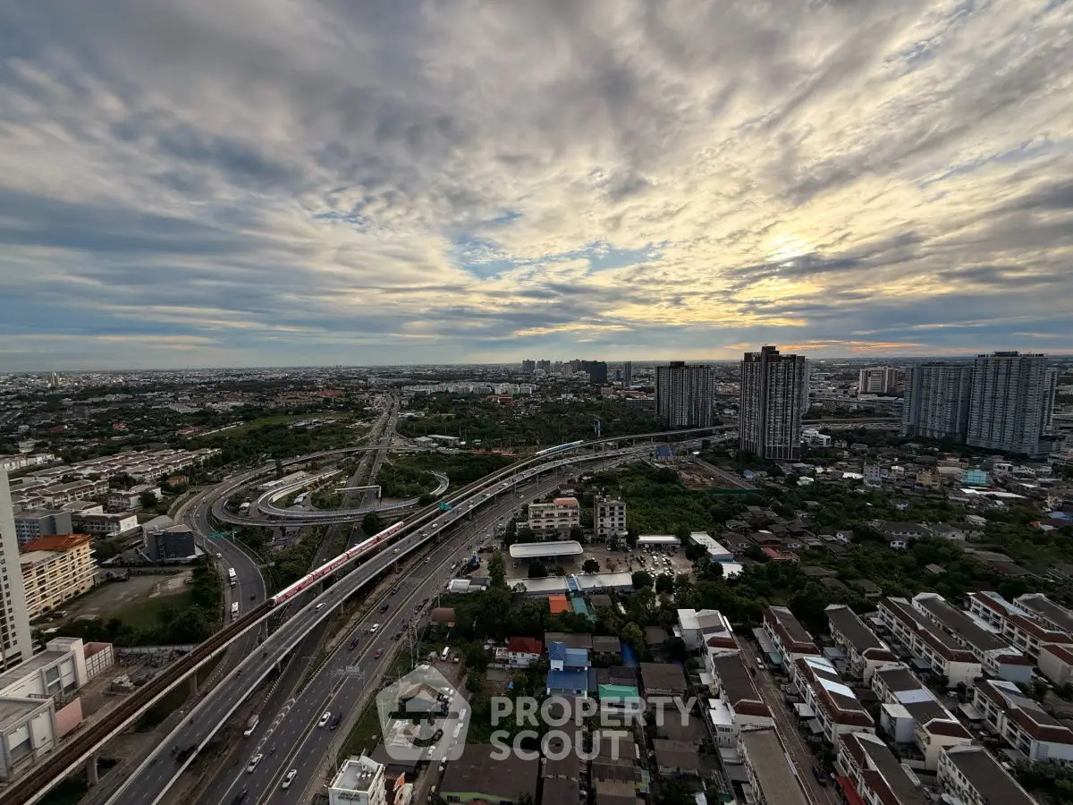 Stunning cityscape view with highways and skyscrapers at sunset, showcasing urban living and connectivity.