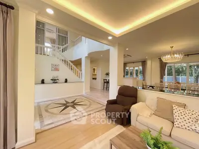 Luxurious open living room with elegant decor and stunning chandelier, perfect for entertaining.