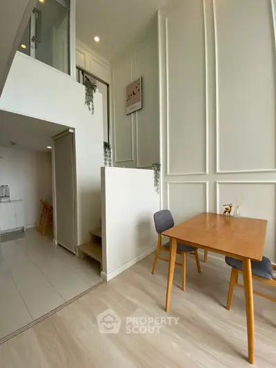 Modern duplex interior with stylish dining area and high ceilings