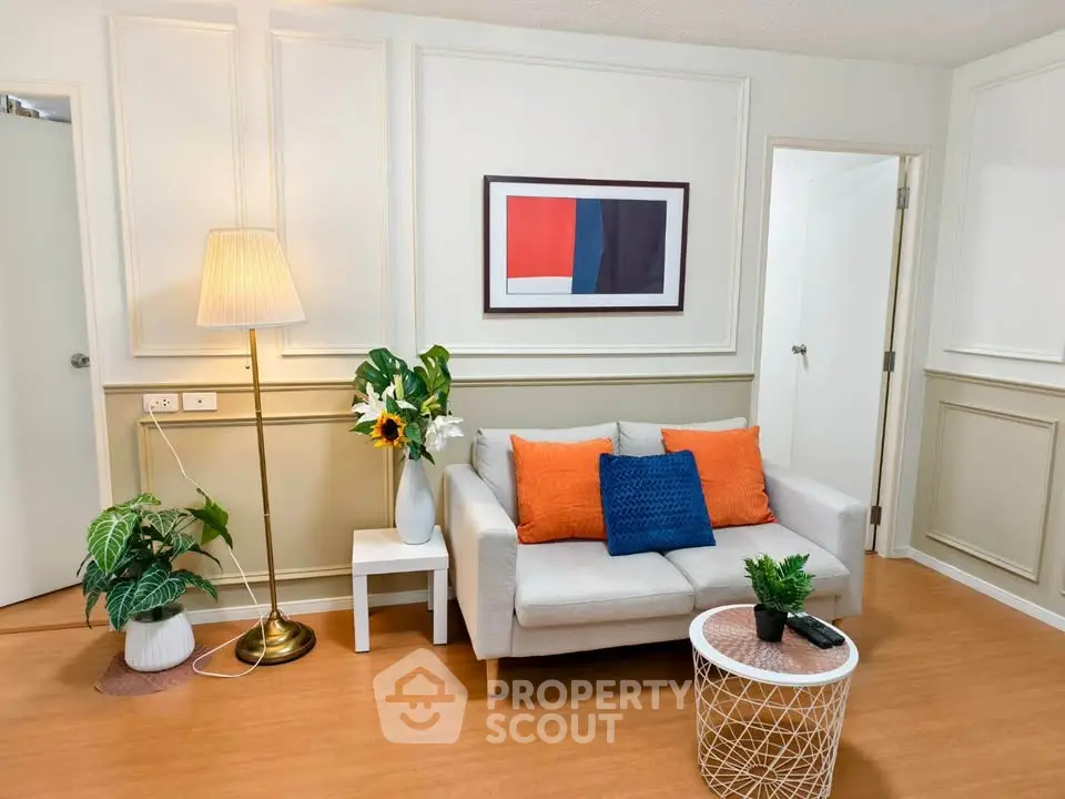 Charming living room with cozy sofa, vibrant cushions, and stylish decor in modern apartment.
