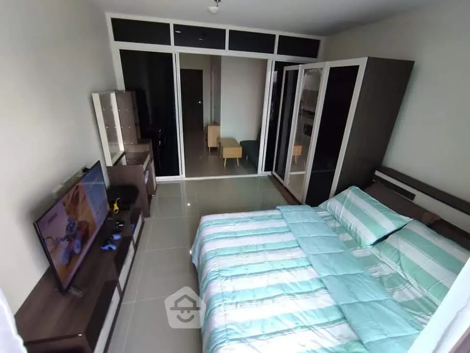 Spacious bedroom with modern decor and large wardrobe in a stylish apartment.