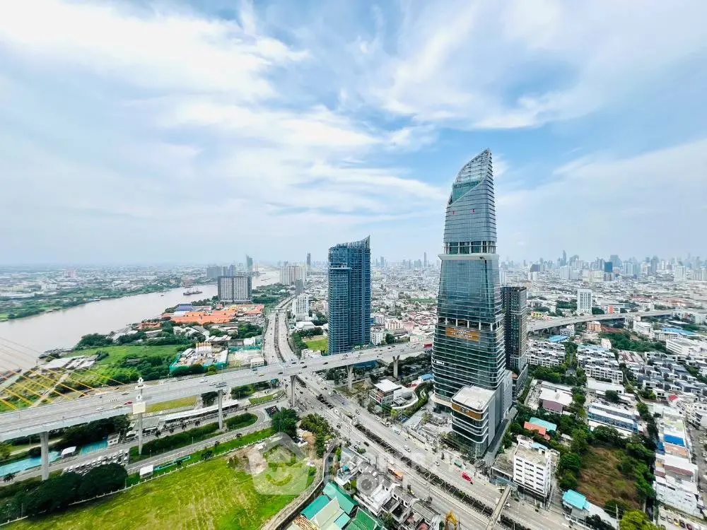 Stunning aerial view of modern skyscrapers in bustling cityscape with river and highway.