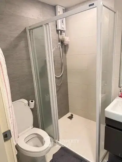 Modern bathroom with glass shower enclosure and sleek fixtures