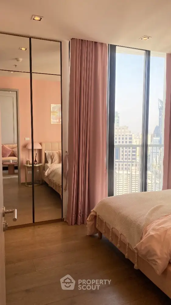 Chic bedroom with floor-to-ceiling windows and city view