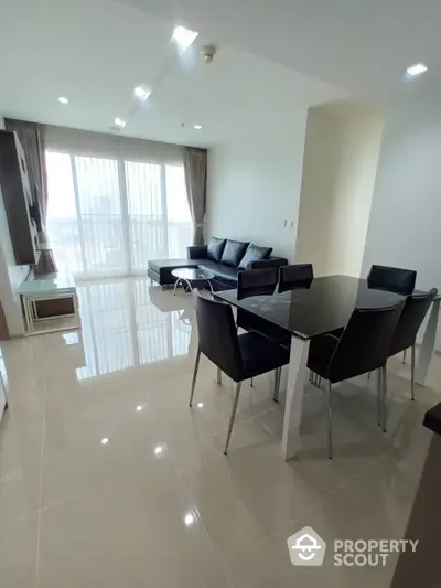 Spacious and modern living room with gleaming tiled floors, contemporary furniture, and ample natural light from large windows, perfect for urban living.