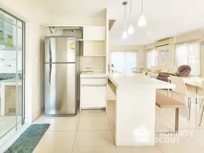 Spacious open-layout kitchen with modern appliances and bright living area