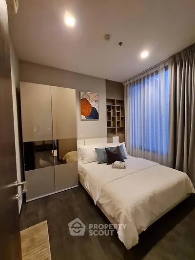 Modern bedroom with stylish decor and ample natural light