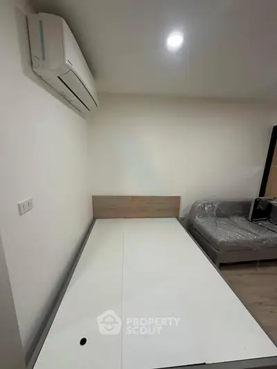 Modern bedroom with air conditioning and minimalist furniture setup