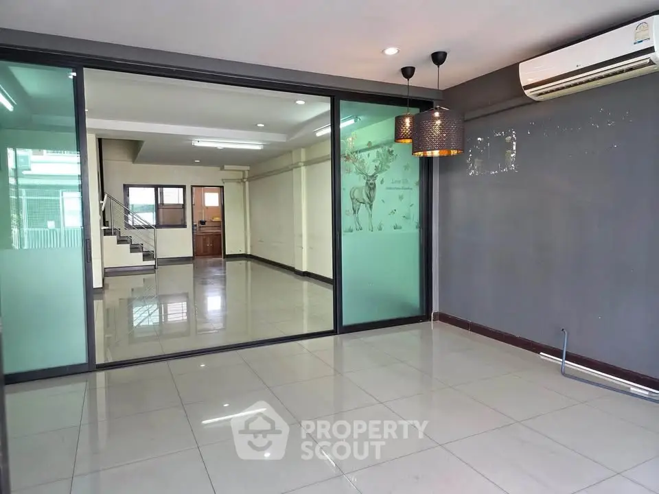 Spacious modern living room with glass partition and air conditioning