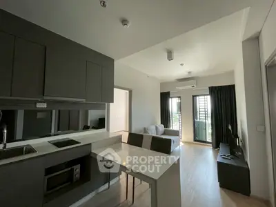 Modern open-plan kitchen and living room with sleek design and natural light