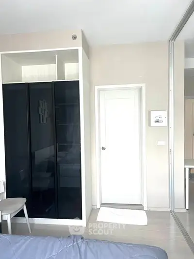 Modern bedroom with sleek wardrobe and minimalist decor