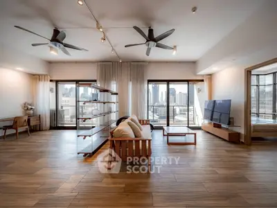 Spacious modern living room with city view and wooden flooring